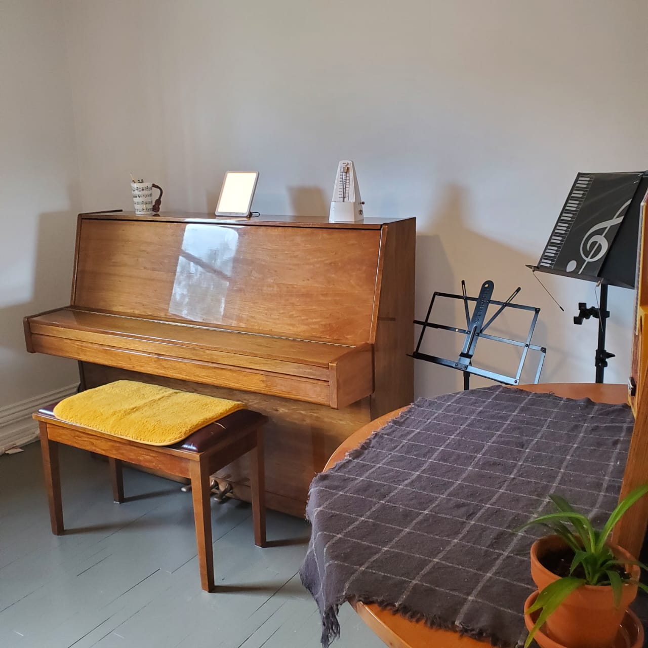 Studio with upright piano and music stand