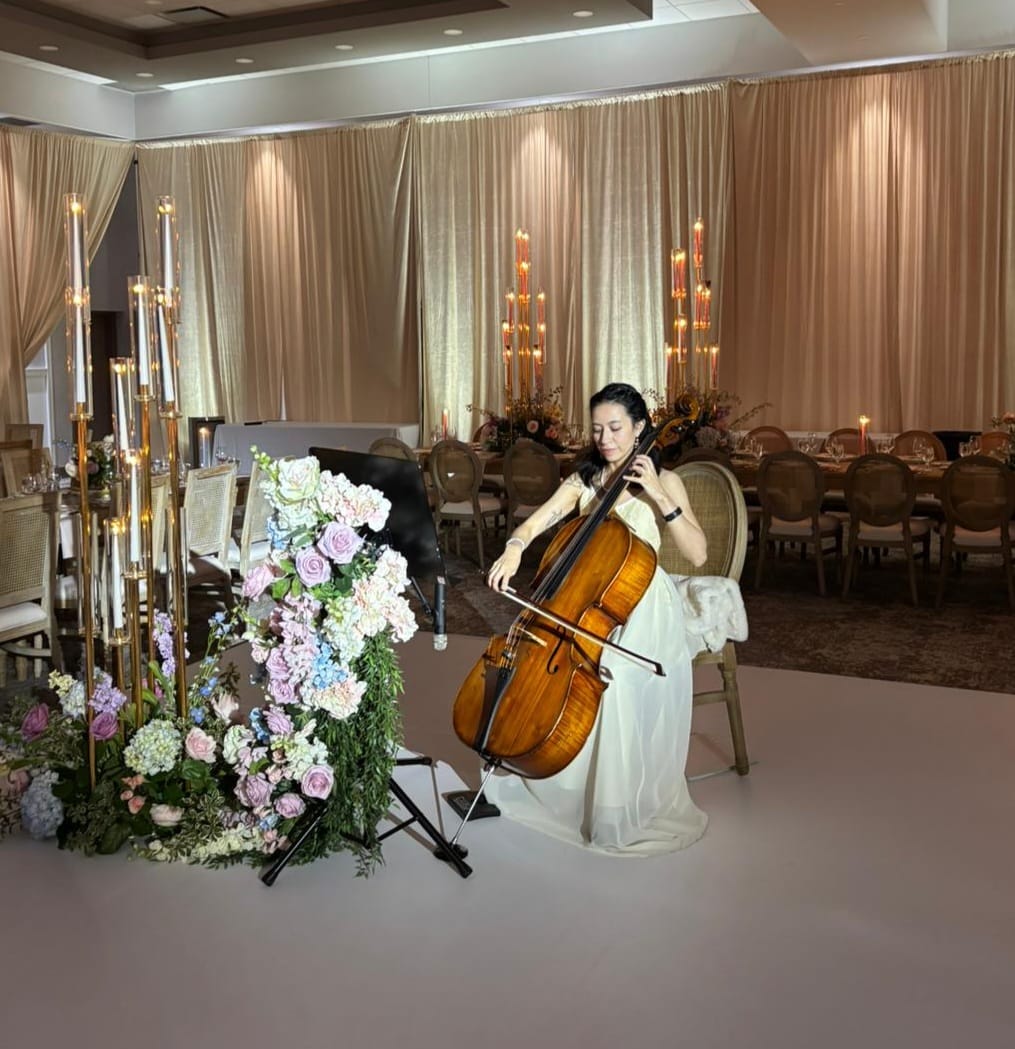 Karol Contreras performing cello at an elegant house concert